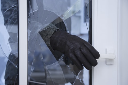 Burgled Hand Reaching Through Broken Glass